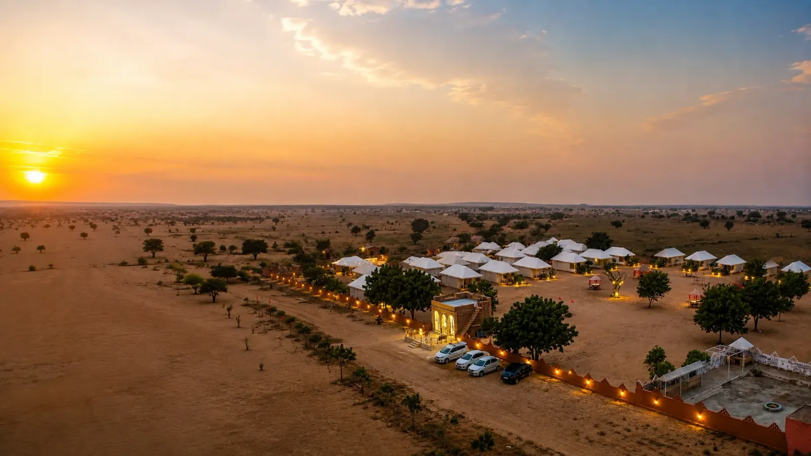 Sunny Desert Camp illuminated on the Khuri dunes at dusk