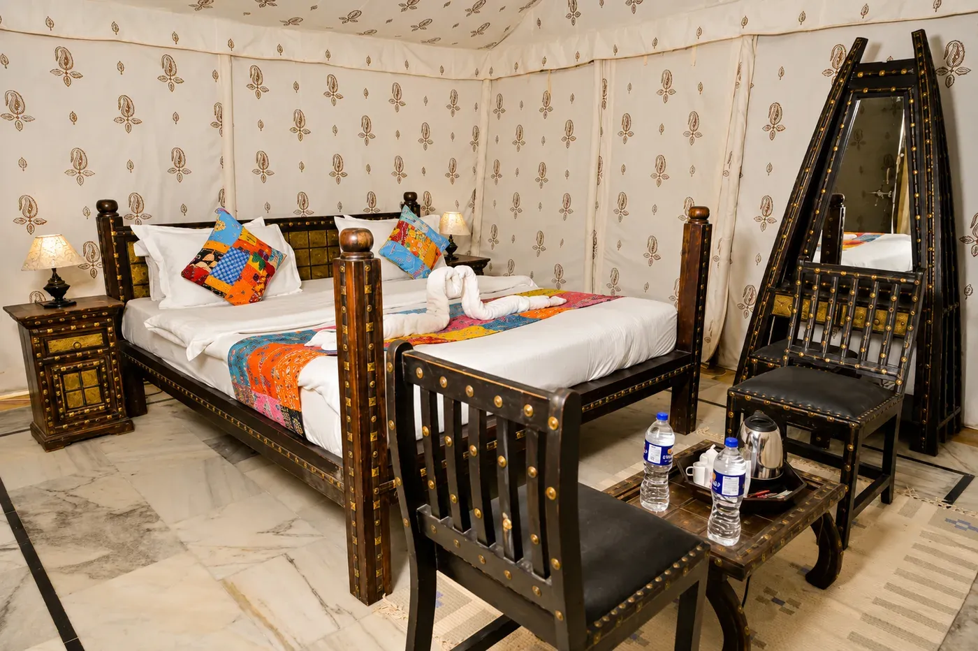 Handcrafted wooden bed and furnishings in Deluxe Tent