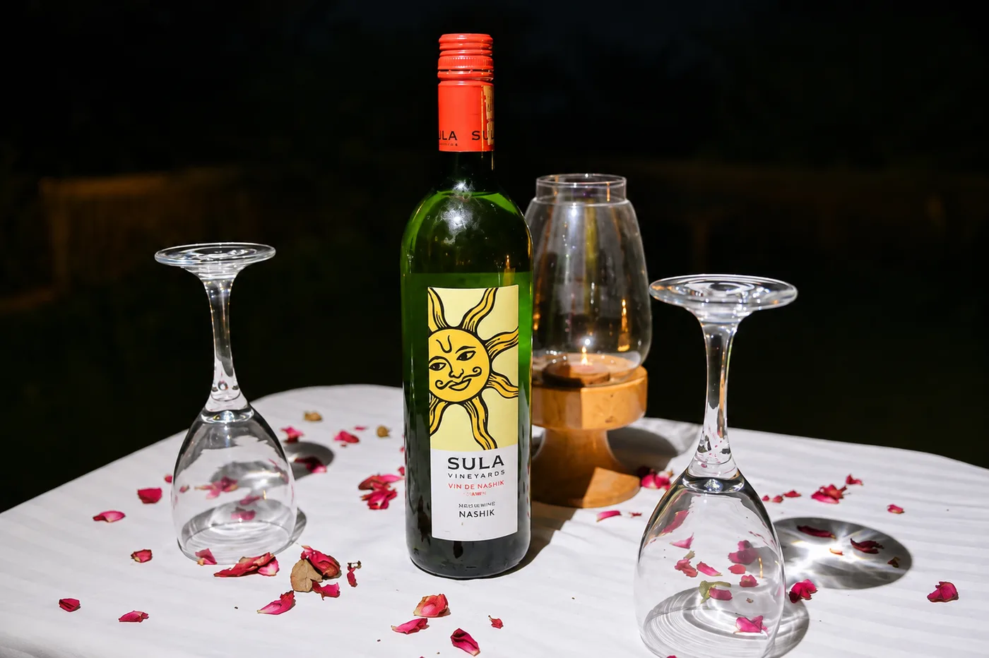 Table arrangement with candle lantern and glassware for evening dining