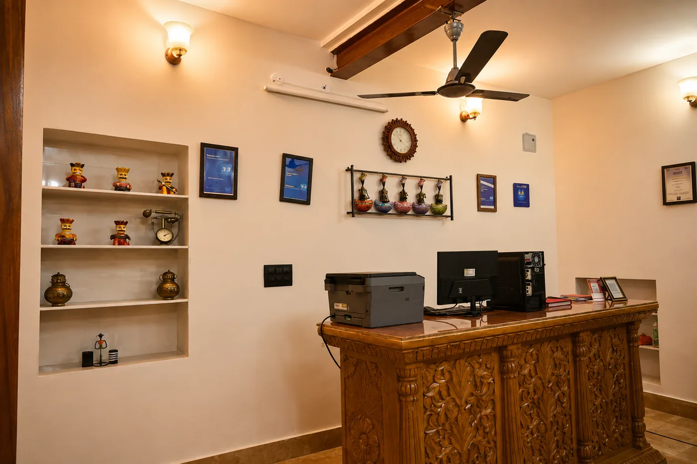 Carved wooden front desk and traditional Rajasthani handicrafts display in reception