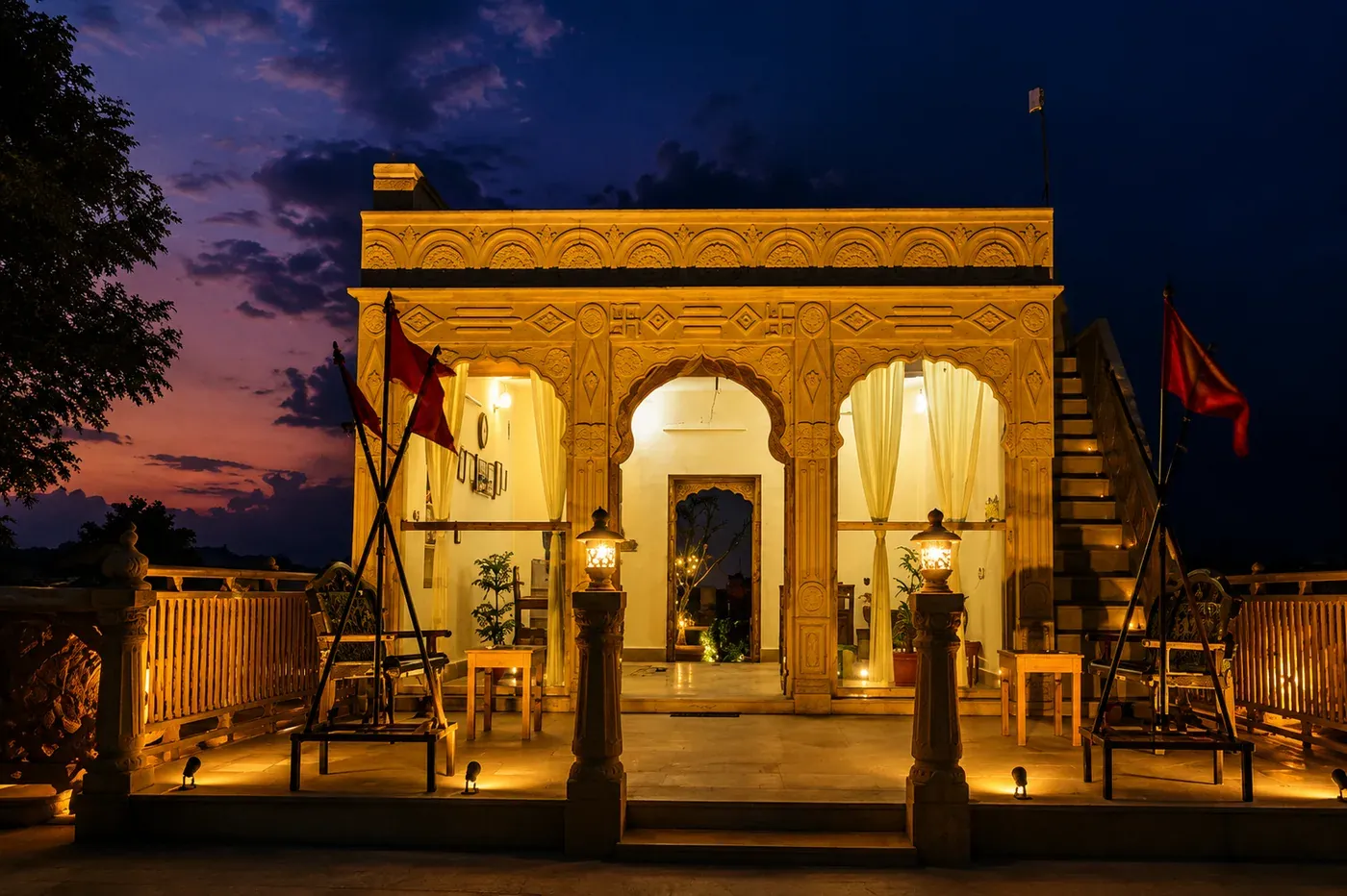 Ornate Jaisalmer yellow sandstone reception pavilion illuminated at sunset
