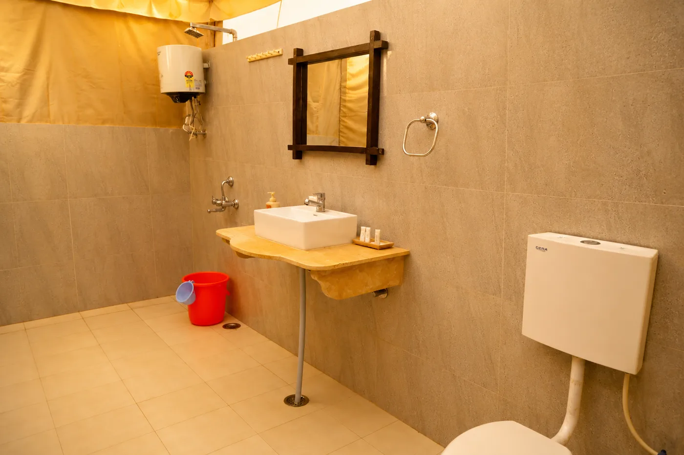 Ensuite bathroom with water geyser and ceramic washbasin